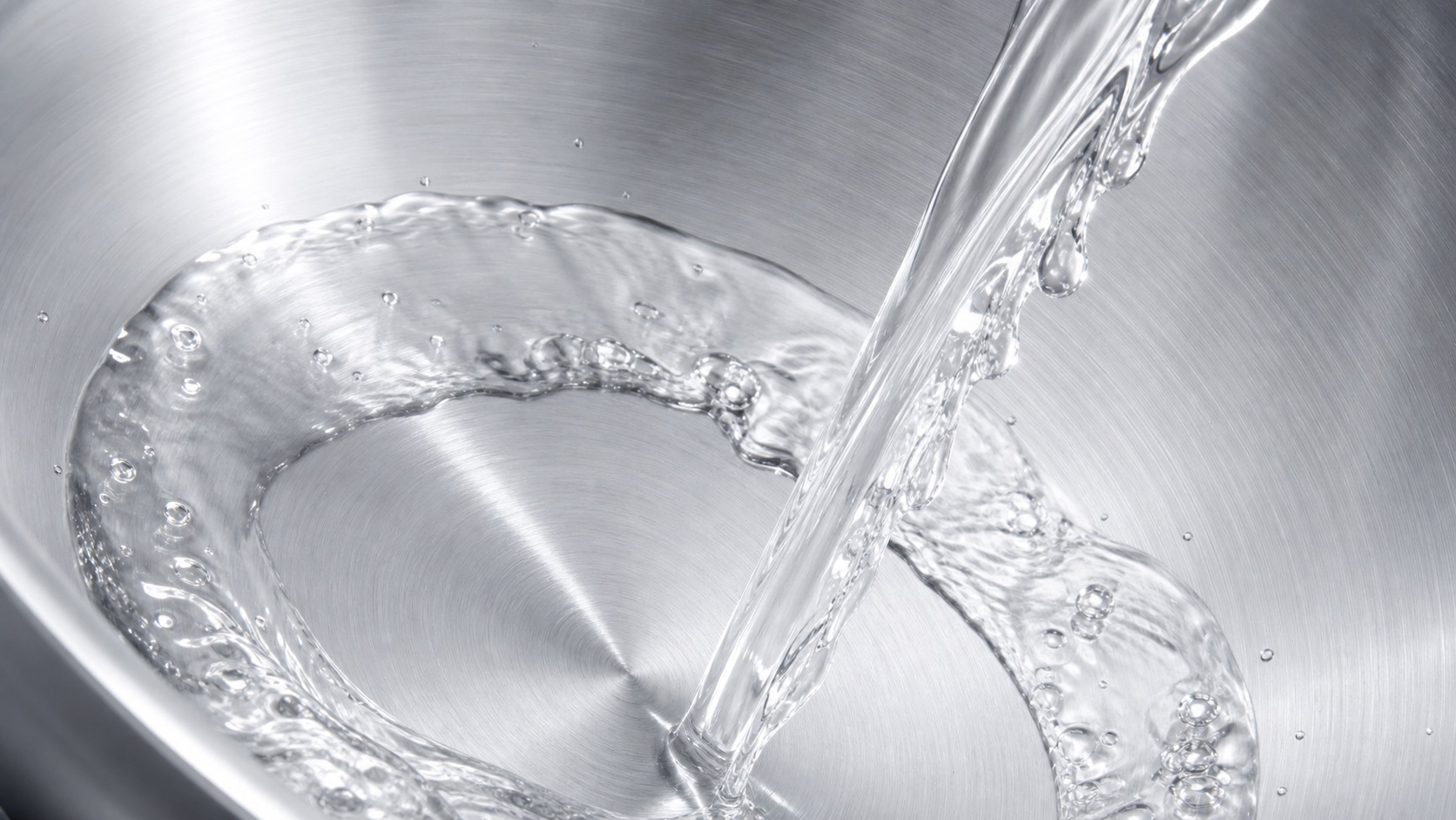 Water rinsing a treated stainless steel pan clean